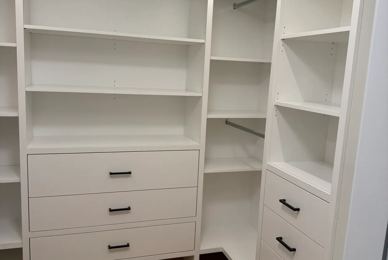 Custom carpentry by Luxe Development - painted walk-in closet built-ins with adjustable shelving