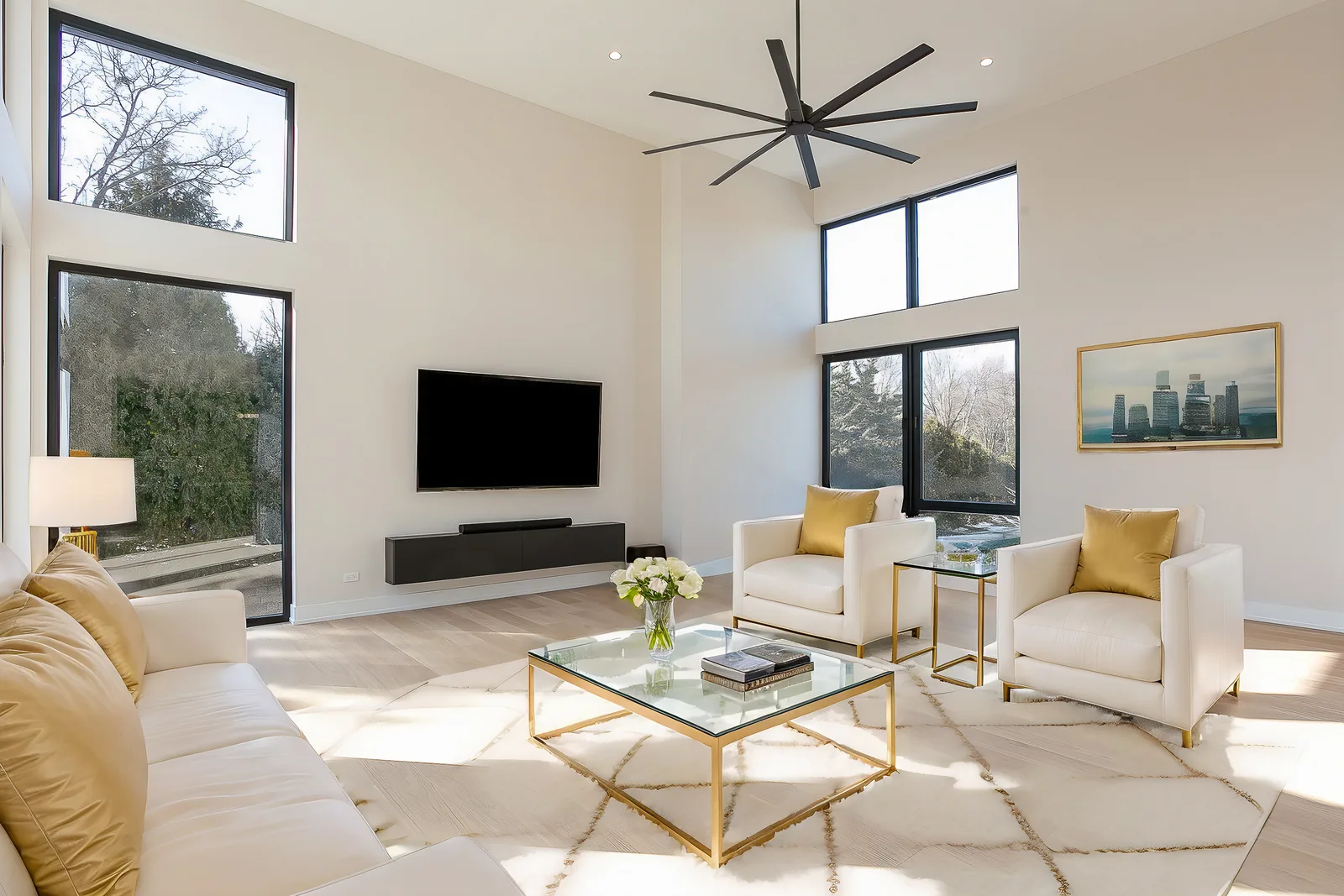 Bright double-height great room in a modern custom home in Lemont, staged with a white sectional and floor-to-ceiling windows, by Luxe Development