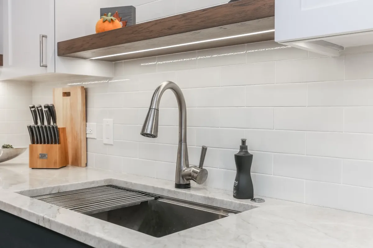 Undermount kitchen sink and pull-down faucet against a full-height tile backsplash, condo renovation in Chicago, IL