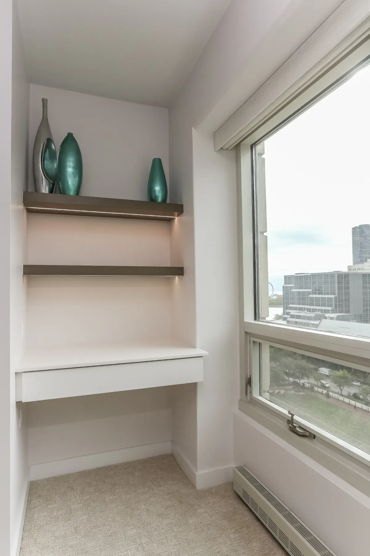 Built-in window bench with stained floating shelves at a full-height window in a Chicago condo renovation