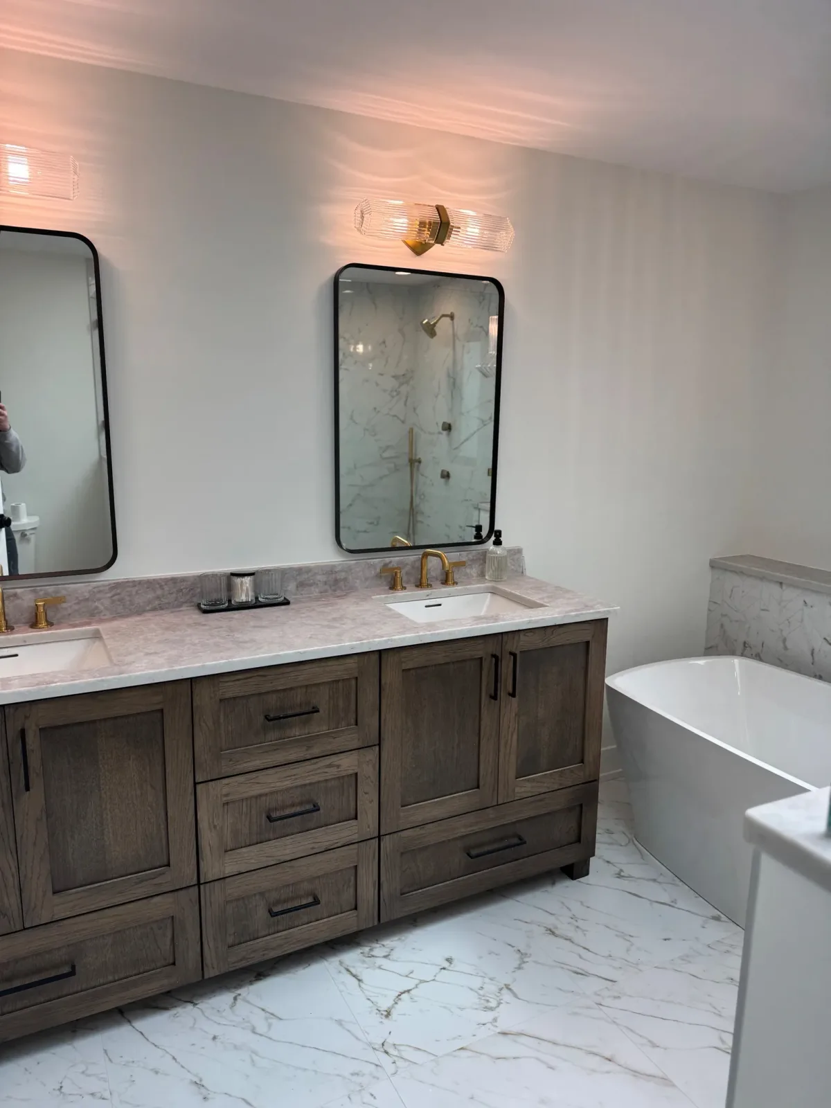 Close view of the stained oak vanity, its marble top and rectangular undermount basin with brass tapware - marble primary bath remodel, Mokena IL