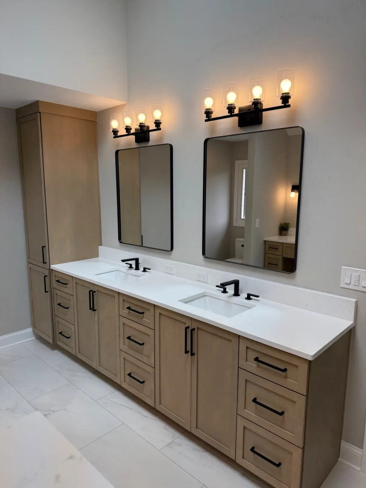 Bathroom remodel after photo, Mokena IL - light shaker double vanity with a white stone-look counter, undermount basins, black-framed mirrors and matte black lighting