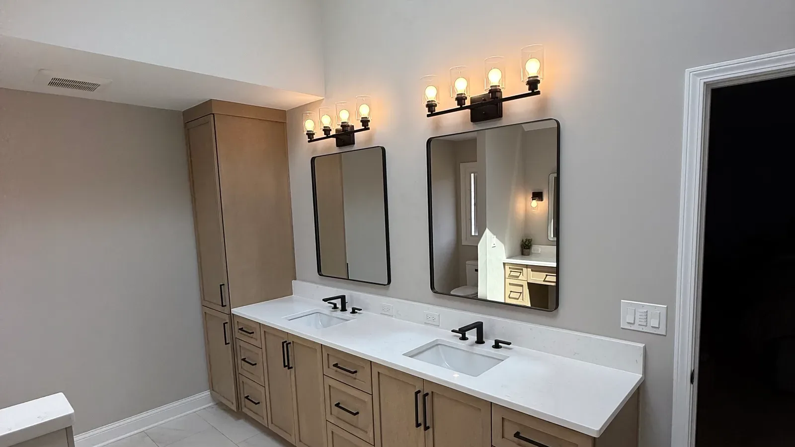 Primary bathroom remodel in Mokena, IL - light shaker double vanity and a white stone-look counter by Luxe Development